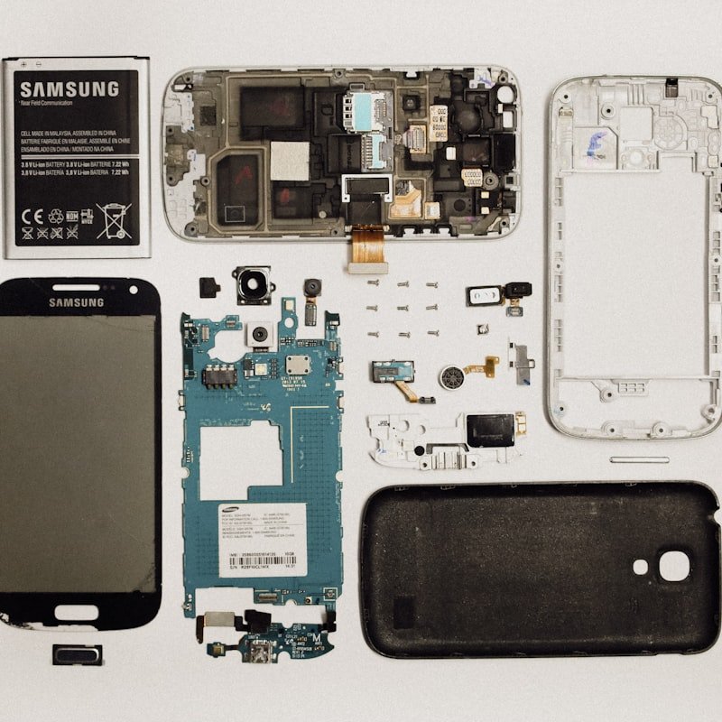 Fully disassembled Samsung Galaxy phone with all components laid out flat